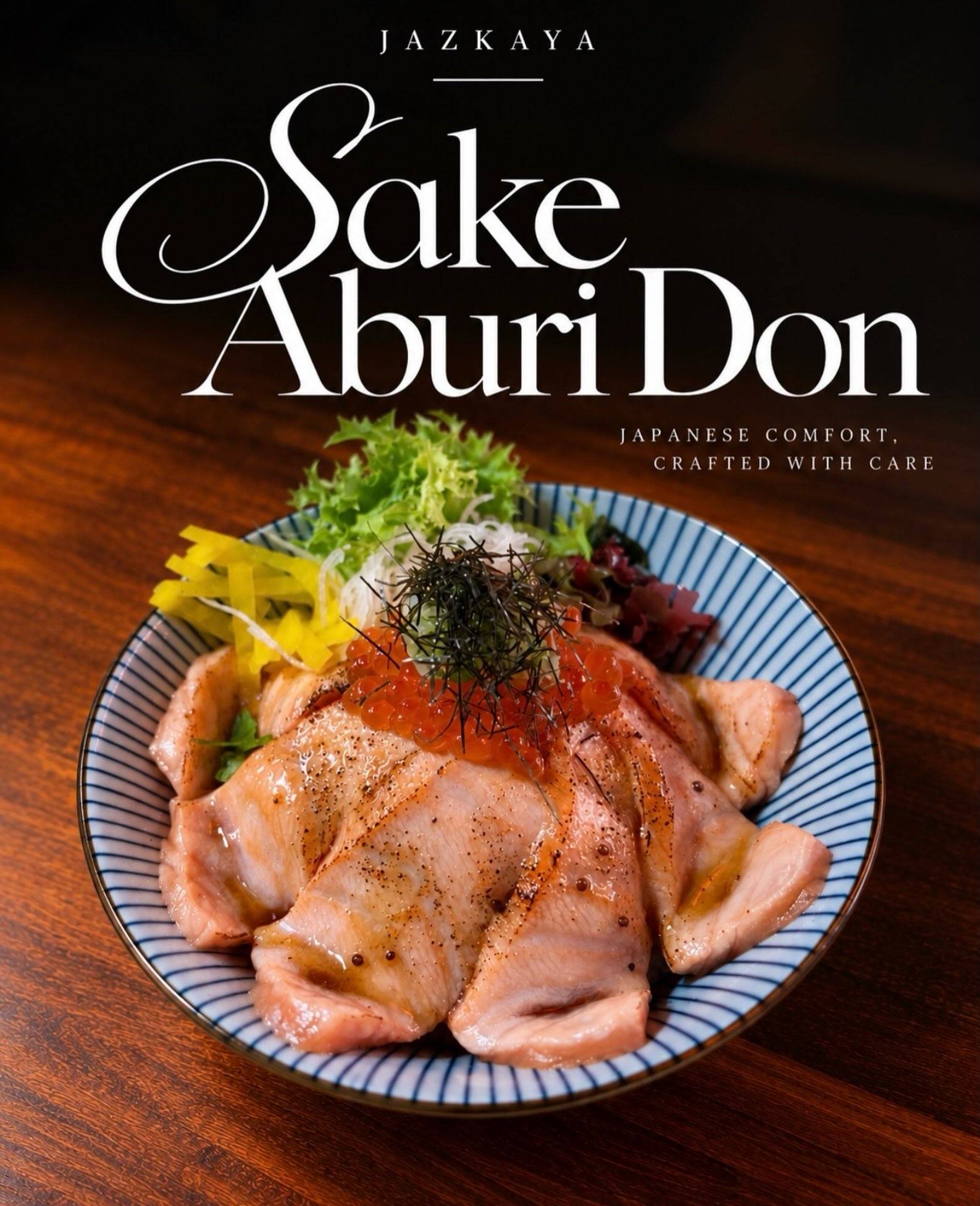 Sake Aburi Don: seared salmon slices over rice with salmon roe and scallions on a blue-rimmed plate.